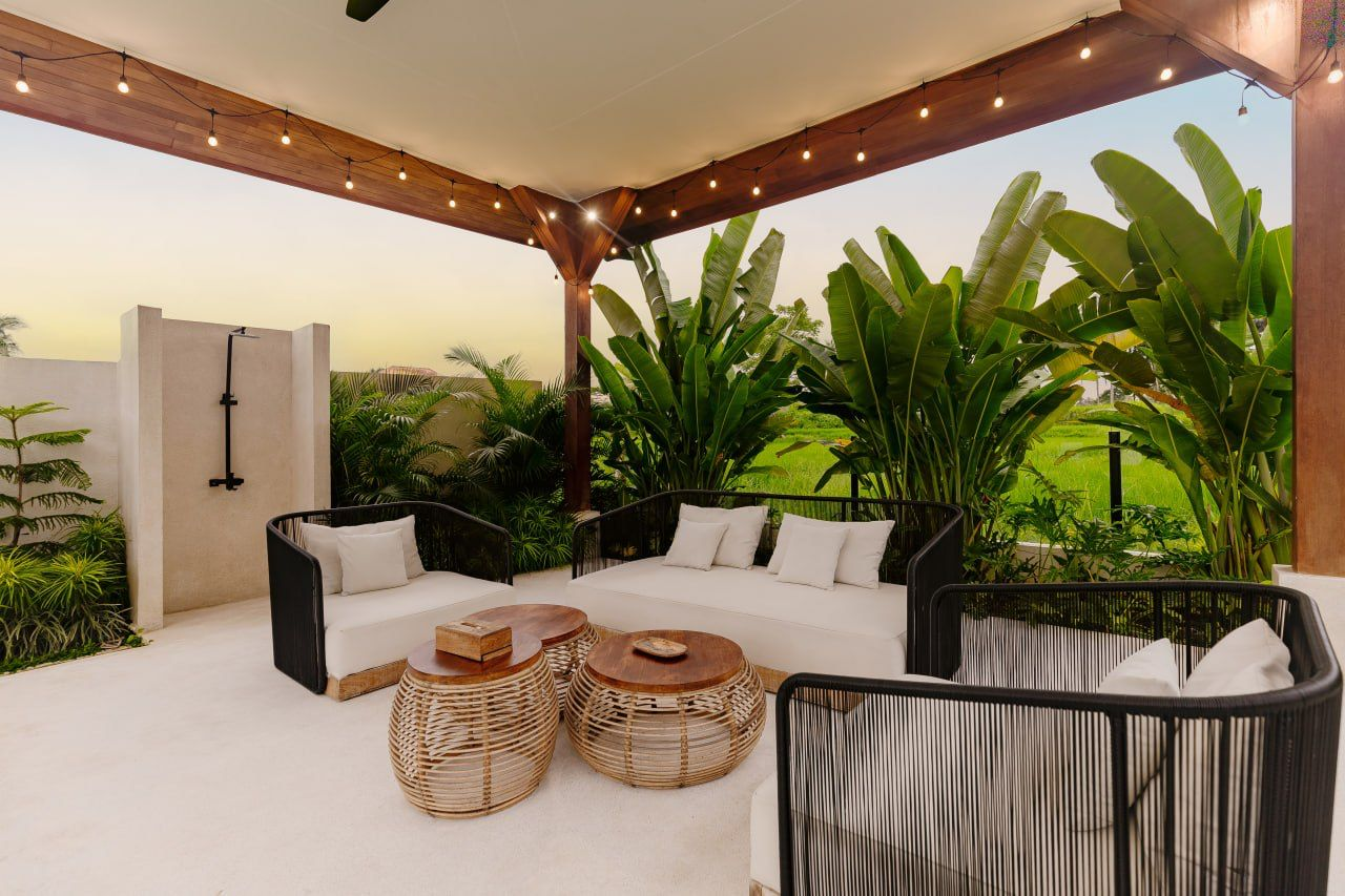 Outdoor villa lounge overlooking tropical greenery